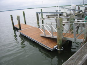 A Ipe wood dock and gangway being held together with rotationally molded, highly durable float drums that can withstand any impact from debris, gas, the sun, and marine lifeforms.